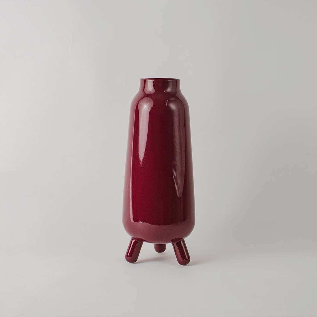 Decorative ceramic vase with deep red glaze sculpted body and minimal design ideal for console table shelf decor.