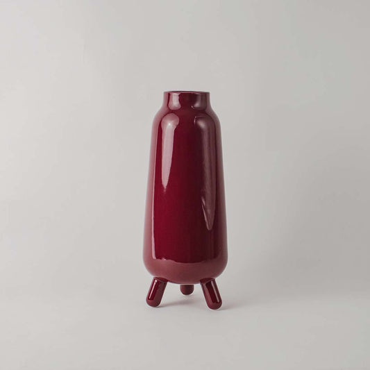 Decorative ceramic vase with deep red glaze sculpted body and minimal design ideal for console table shelf decor.
