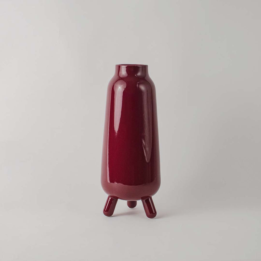 Decorative ceramic vase with deep red glaze sculpted body and minimal design ideal for console table shelf decor.