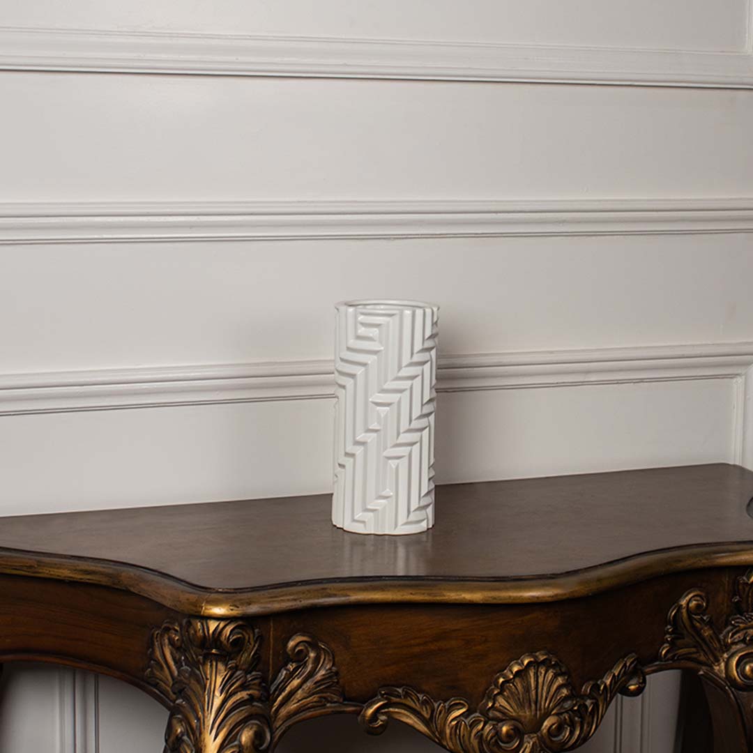 A white geometric pattern vase presented on a clean white background highlighting its tall elegant shape and modern carved texture.