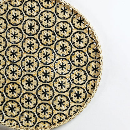 Closeup of handcrafted wall basket featuring black and natural star motifs highlighting intricate weaving and premium artisan detailing.