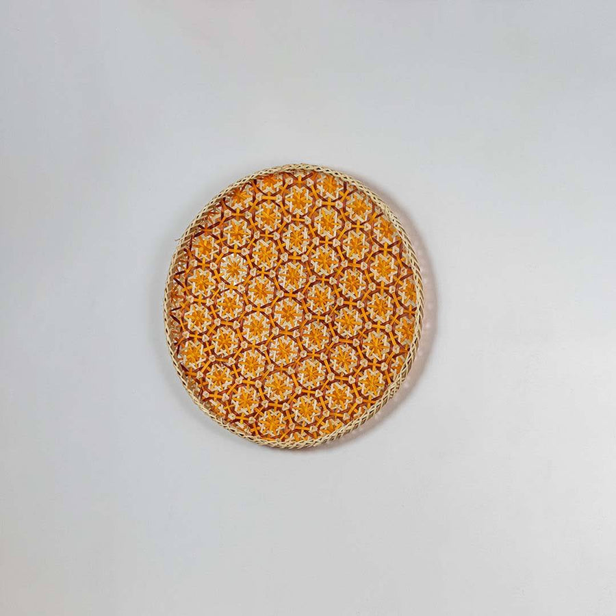 Natural woven orange and beige seagrass wall basket for living room boho décor on white background image.