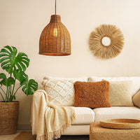 Brown woven rattan pendant light above sofa creating warm bohemian ambiance and relaxed comfort.