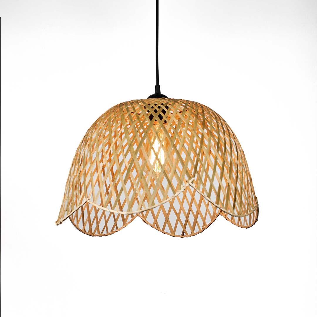 Scalloped edge wicker pendant light with curved woven pattern and soft dome shape suspended against neutral wall background for elegant natural decor.

