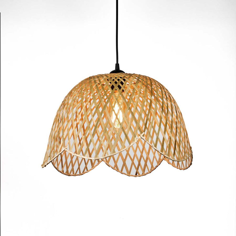Scalloped edge wicker pendant light with curved woven pattern and soft dome shape suspended against neutral wall background for elegant natural decor.

