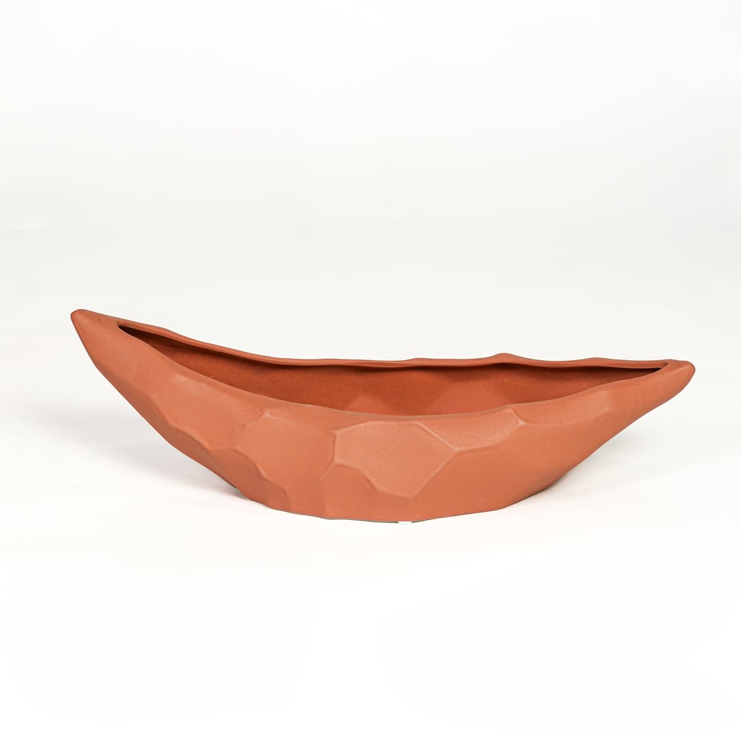 Orange ceramic decorative platter with angular textured finish isolated on clean white background for stylish home decor display.