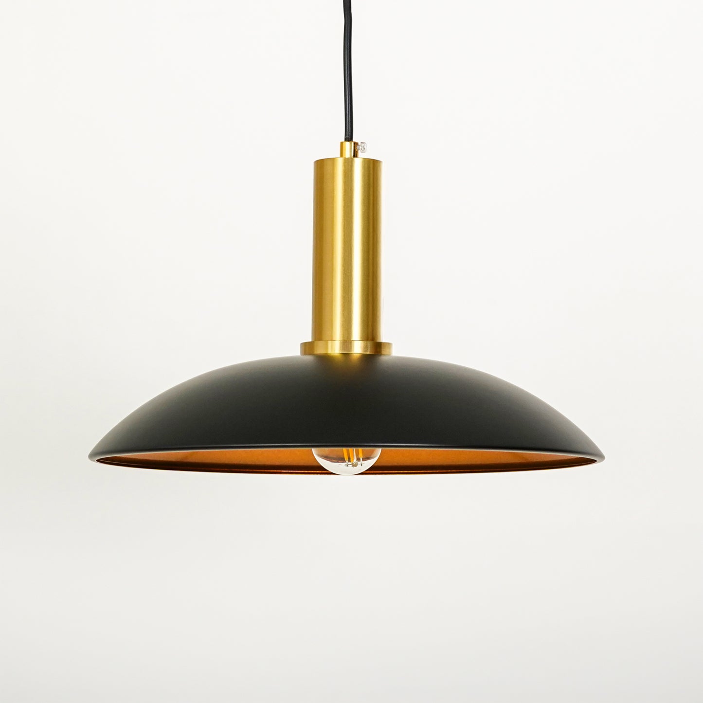 White background image of barn style black gold metal lamp for modern dining room decor styling with smooth matte finish.