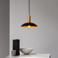Lifestyle image of barn style black gold metal hanging lamp for elegant dining room decor styling with beautiful finish.