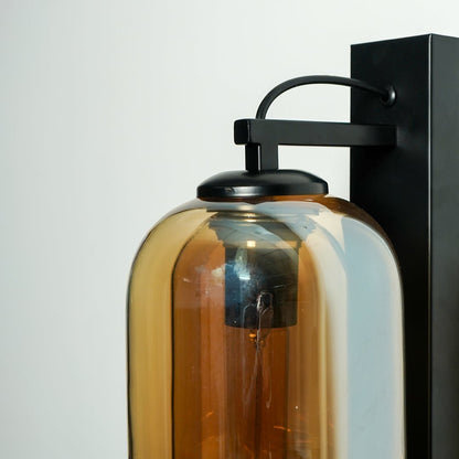 Closeup of amber glass and black metal wall light for modern hallway and luxury decor styling spaces.