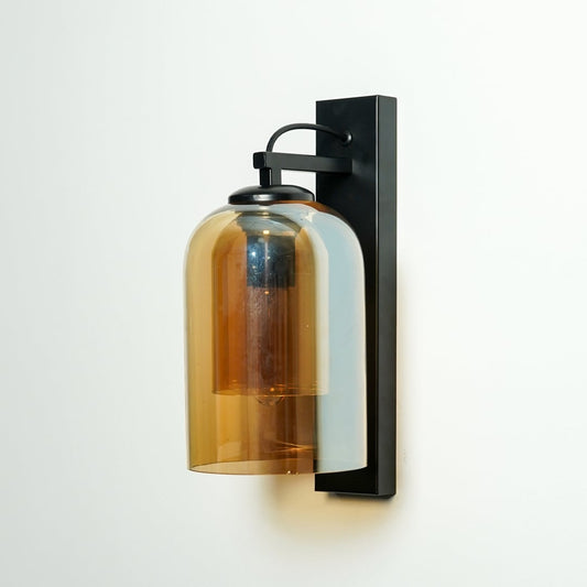 Closeup of amber glass and black metal wall light for modern bedroom and luxury decor styling spaces.

