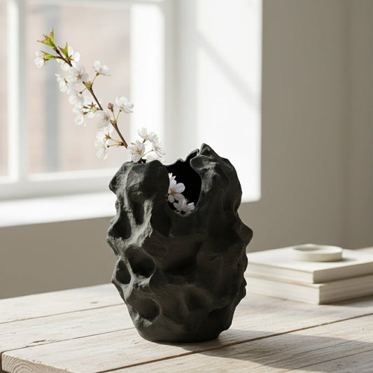 Black sculptural ceramic vase styled on living room console modern decorative ceramic accent for shelf table or corner styling home.
