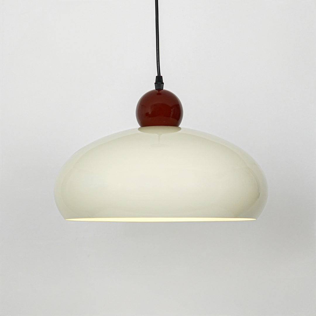 Modern cream and burgundy pendant light suspended on white background for luxury dining room decor styling.