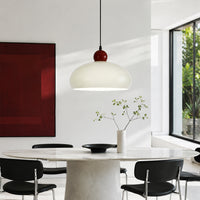 White dome pendant light styled above dining table creating elegant ambiance in contemporary interiors.