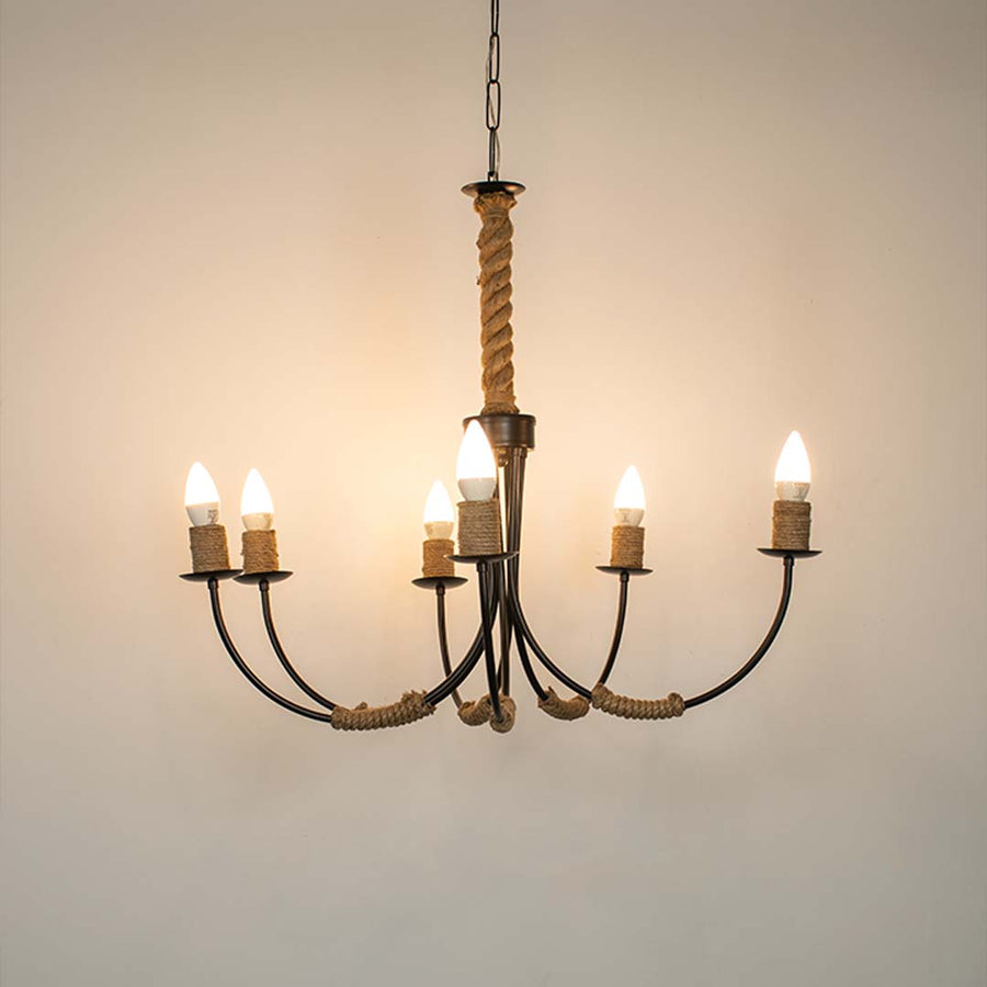 Modern black metal chandelier with five candle style lights suspended above dining space creating elegant ambient home lighting.