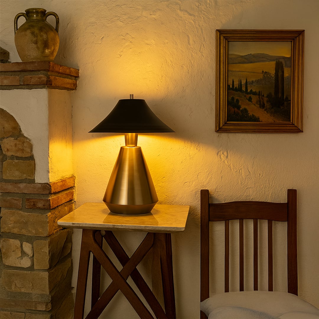 Warmly lit corner featuring a metal table lamp with a black shade on a marble-top table creating a cozy and elegant ambience.