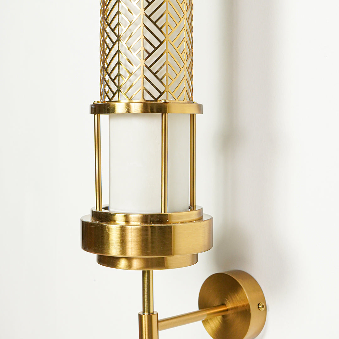 Close view of gold wall light with patterned glass tube showcasing premium craftsmanship and elegant modern lighting design.