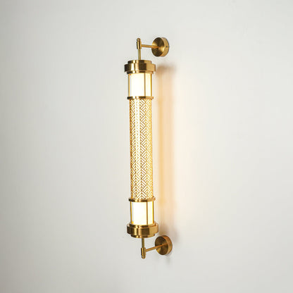 Gold wall light with dual glass tube shades mounted on neutral wall background ideal for modern luxury bedroom or hallway lighting.
