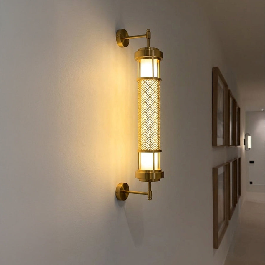 Gold wall light with vertical frosted glass tube mounted on neutral wall background ideal for modern bedroom or hallway lighting.

