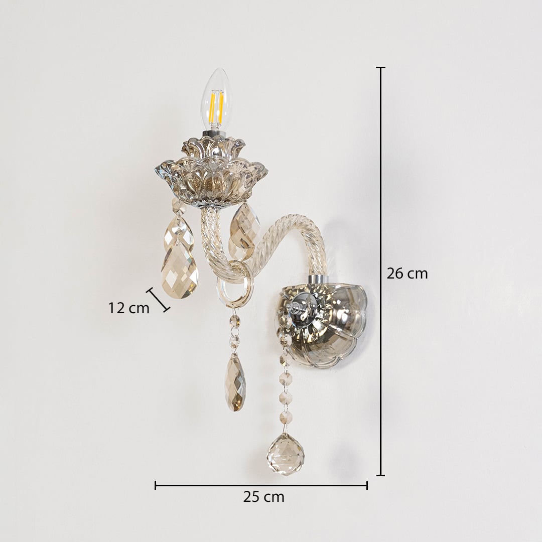 Crystal wall light with glass shade and hanging crystals size 25cm height 26cm width 12cm depth displayed with measurements.