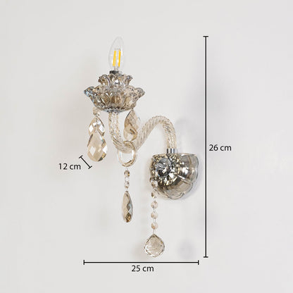 Crystal wall light with glass shade and hanging crystals size 25cm height 26cm width 12cm depth displayed with measurements.