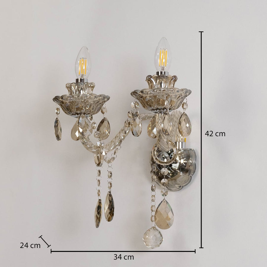 Crystal wall light with glass shade and hanging crystals size 25cm height 26cm width 12cm depth displayed with measurements.