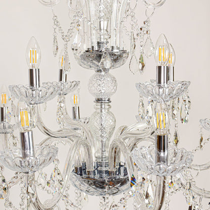 Closeup of large clear crystal chandelier with detailed crystal strands and curved arms perfect for luxury ceiling decor.