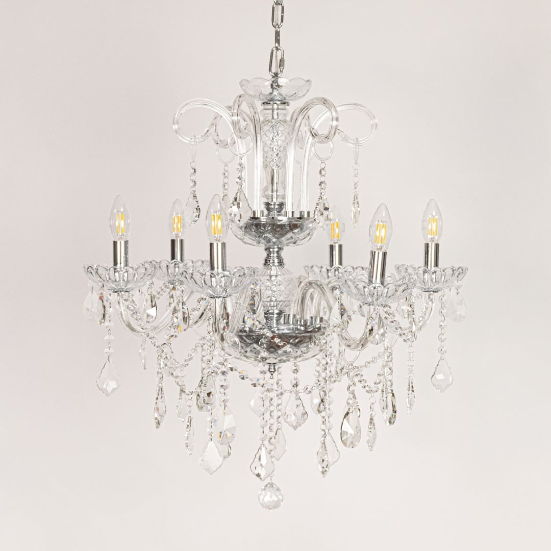 Clear crystal chandelier displayed on white background ideal for classic bright interior ceiling styling.