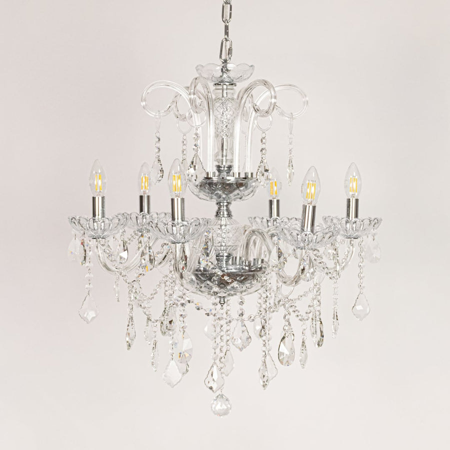 Clear crystal chandelier displayed on white background ideal for classic bright interior ceiling styling.