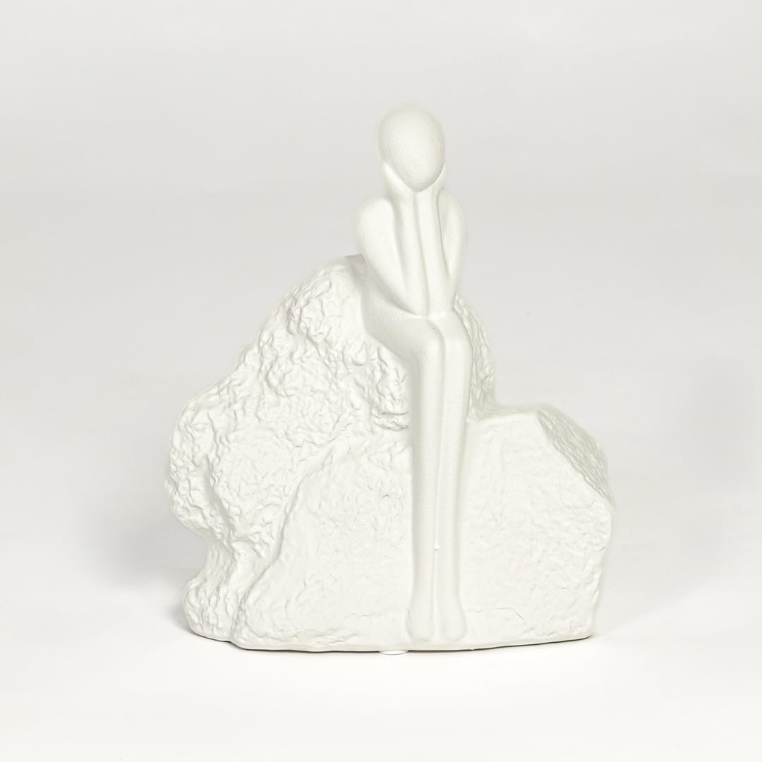 Contemporary white ceramic decorative sculpture with seated figure design for modern home decor styling.