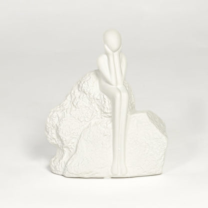 Contemporary white ceramic decorative sculpture with seated figure design for modern home decor styling.