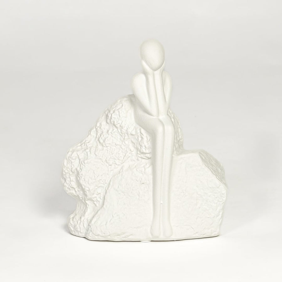 Contemporary white ceramic decorative sculpture with seated figure design for modern home decor styling.