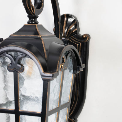 Closeup image highlights black metal frame and textured clear glass of outdoor wall lantern for durable exterior use.