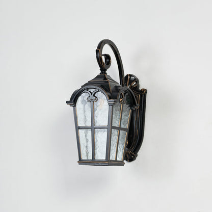 Light off white background displays black metal outdoor wall lantern with clear glass highlighting structure finish and design.