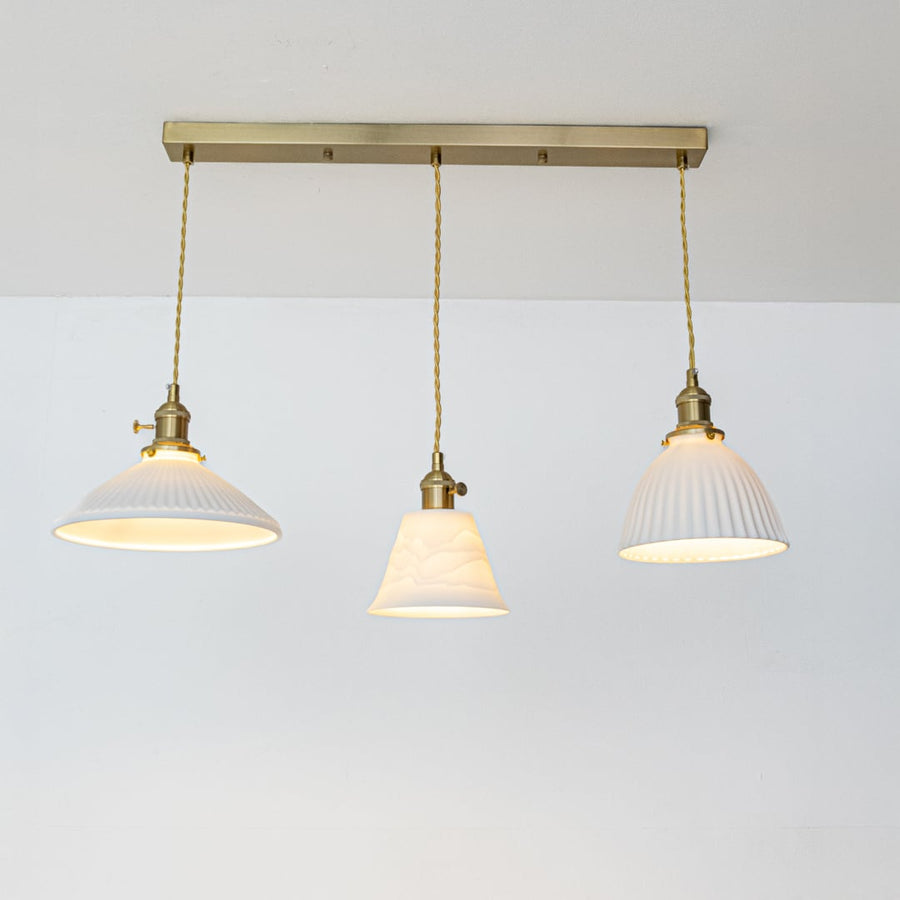 White metal pendant lights with gold accents showcasing stylish designs for contemporary home decor.