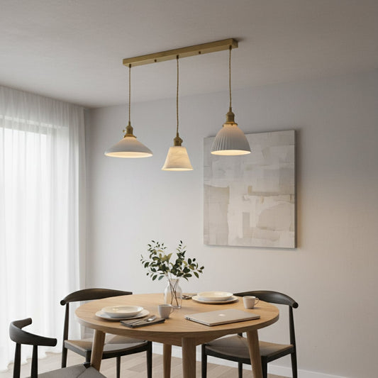 White metal pendant lights adding warm elegance above the dining table in modern interiors.