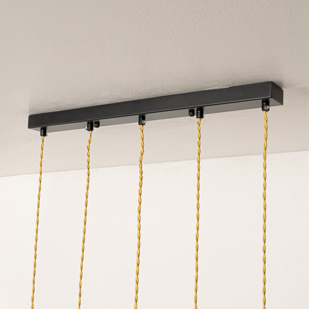 Black metal linear ceiling canopy with decorative chains showcasing premium finish and craftsmanship.