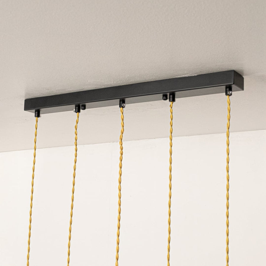 Black metal linear ceiling canopy with decorative chains showcasing premium finish and craftsmanship.