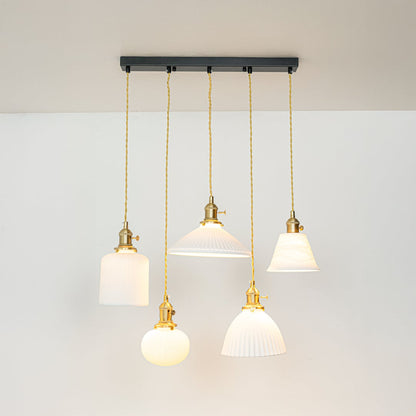 White glass and gold metal pendant lights designed for sophisticated contemporary home decor spaces.