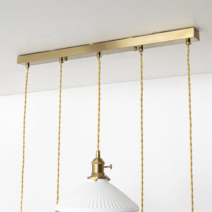 Gold metal linear canopy with decorative chains showcasing premium finish and modern craftsmanship.