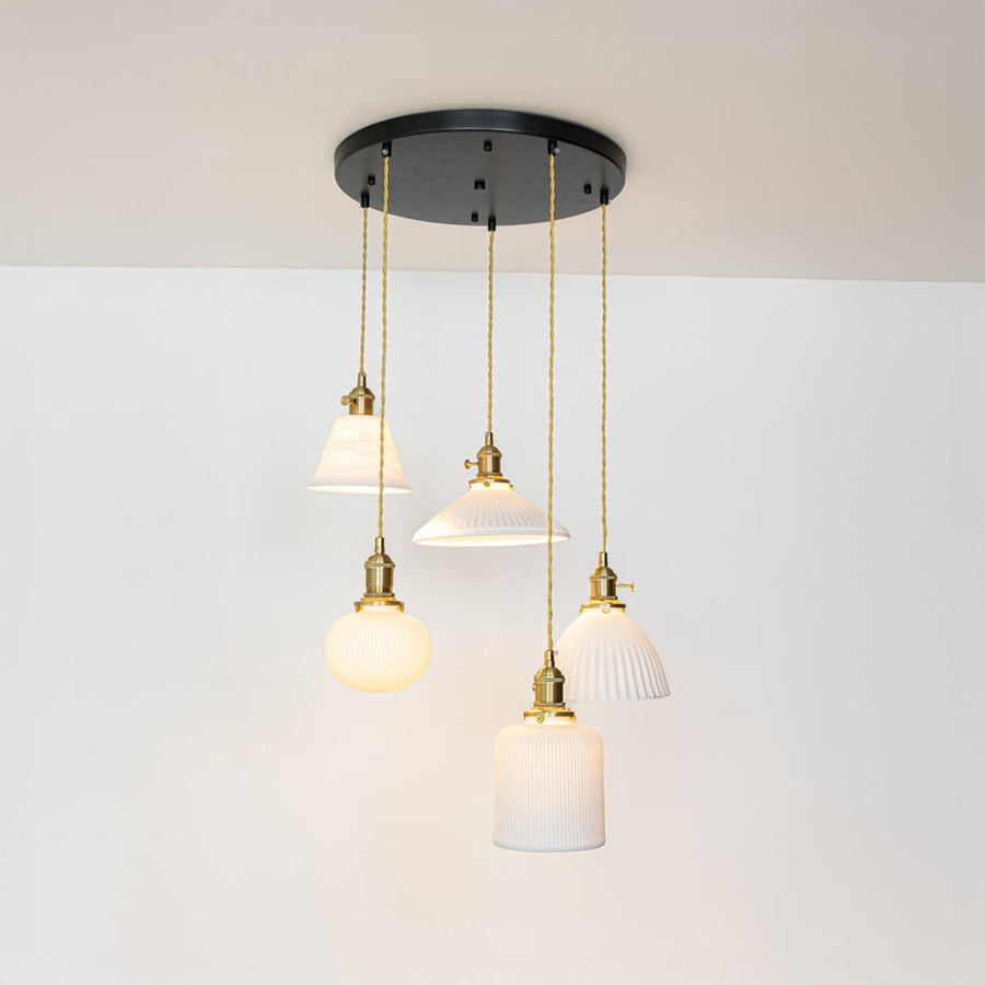 White glass and gold metal pendant lights showcasing refined designs for stylish home decor spaces.