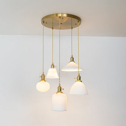 White glass and gold metal pendant lights designed for sophisticated modern home decor spaces.