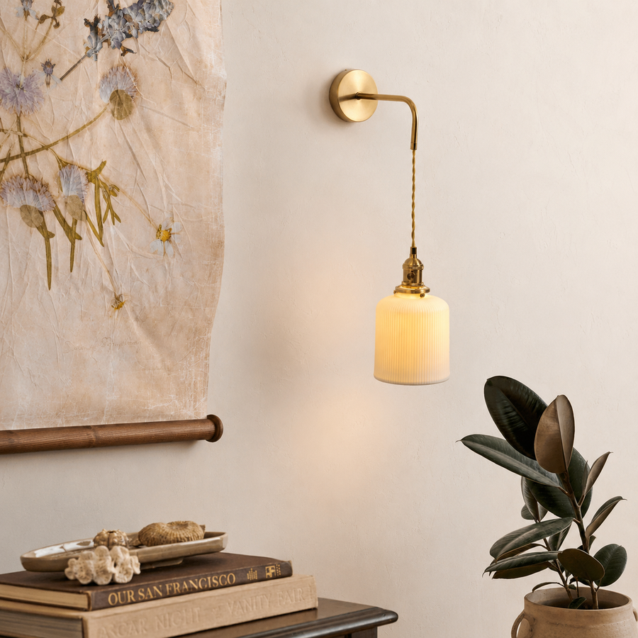 Lifestyle image of cylinder pleated wall hanging light for elegant bedroom decor styling and modern home lighting design.
