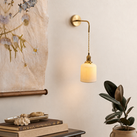 Lifestyle image of cylinder pleated wall hanging light for elegant bedroom decor styling and modern home lighting design.