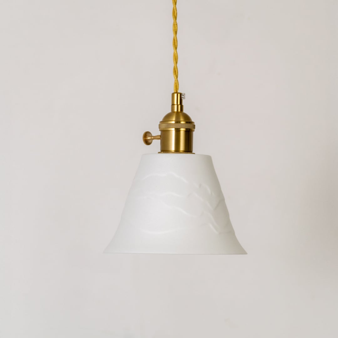 White fabric pendant light with gold metal accents for dining room and kitchen interiors.
