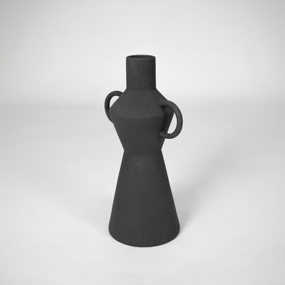 Black textured ceramic vase for modern shelf placement and elegant living room decor styling accent display piece.