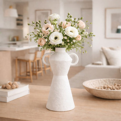 White ceramic decorative flower vase placed on wooden table with fresh flowers modern living room home decor styling idea.