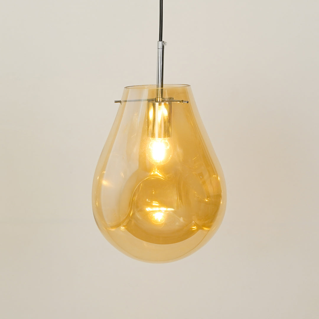 Amber glass pendant light illuminated beautifully for stylish ceiling lighting and home decor.
