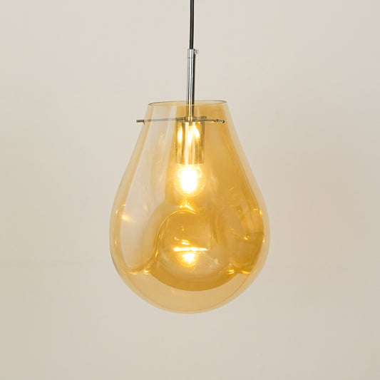 Amber glass pendant light illuminated beautifully for stylish ceiling lighting and home decor.