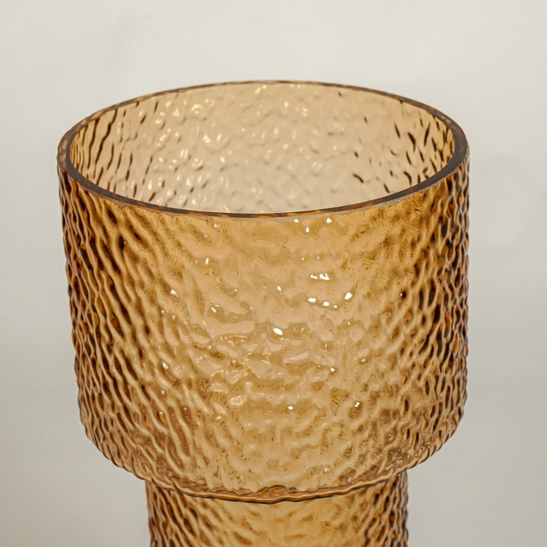 Close up view amber decorative glass vase showing rich color texture luxury glass accent piece for console shelf styling home.