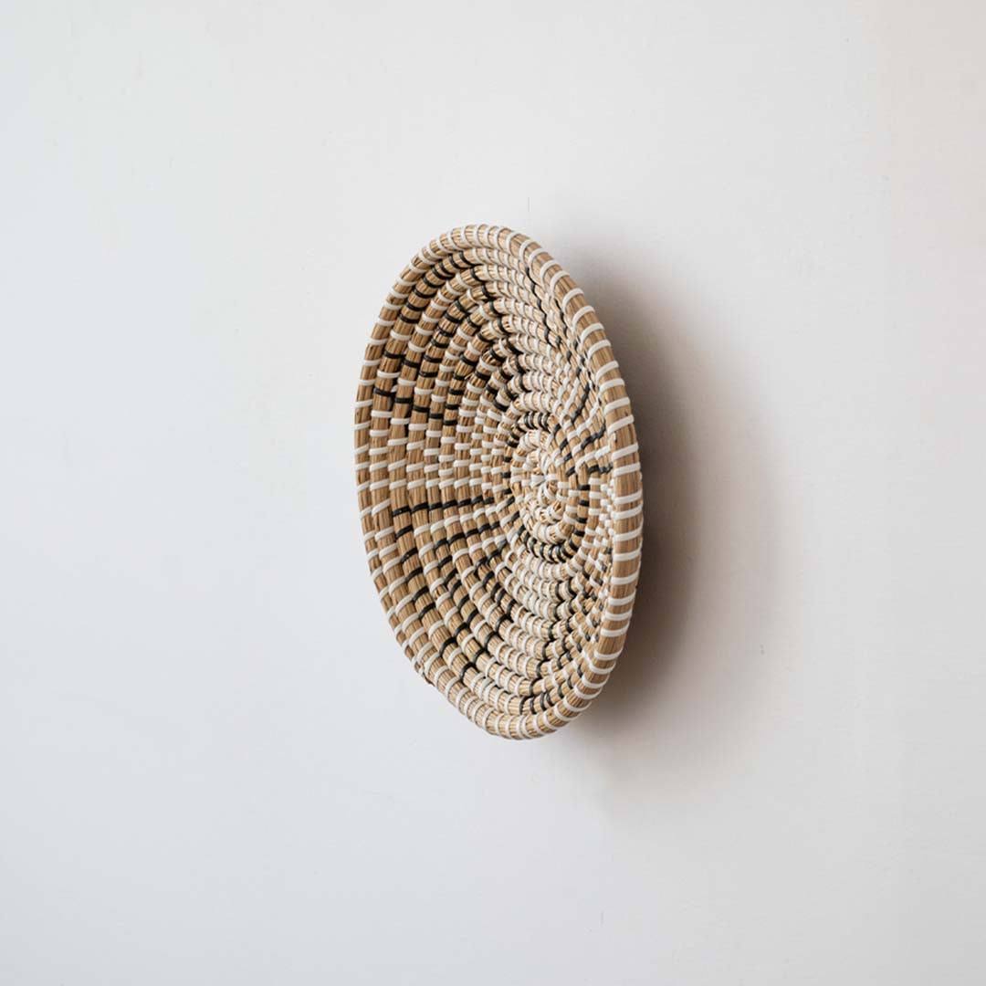 Butterfly pattern black and beige woven seagrass wall hanging basket plate featuring a size line indicator on white.